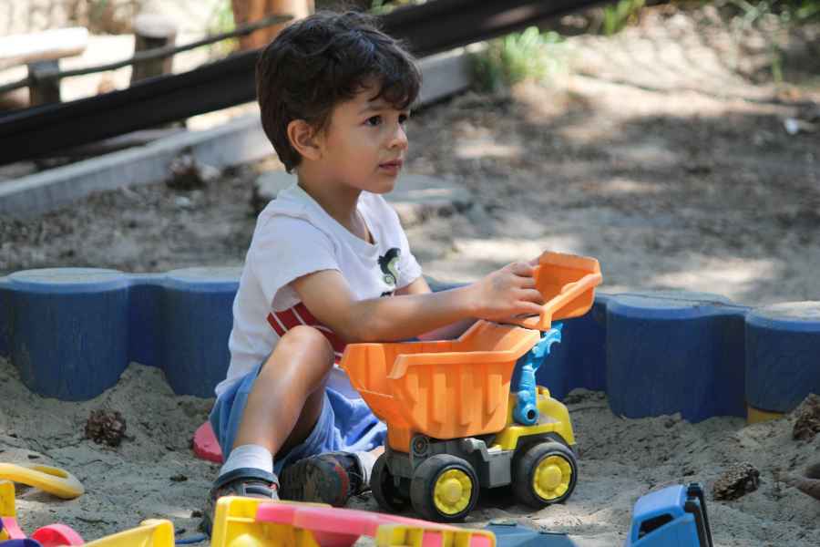 boy playing in a sandbox